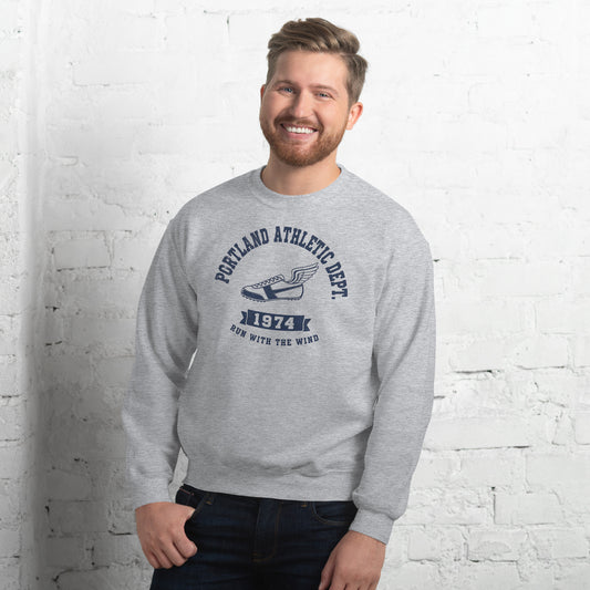  Hombre sonriendo con sudadera gris y diseño clásico de atletismo.