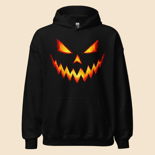 Sudadera negra con capucha y diseño frontal de calabaza de Halloween iluminada en naranja y amarillo